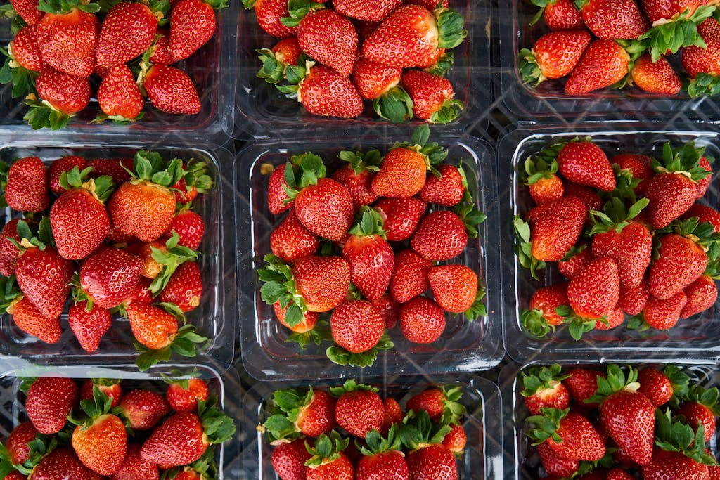 Top View Photo of Strawberries on Plastic Container